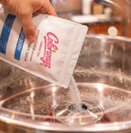Pouring Colorwayz blueberry cotton candy sugar into cotton candy machine, naturally flavored and colored dye-free floss sugar in use