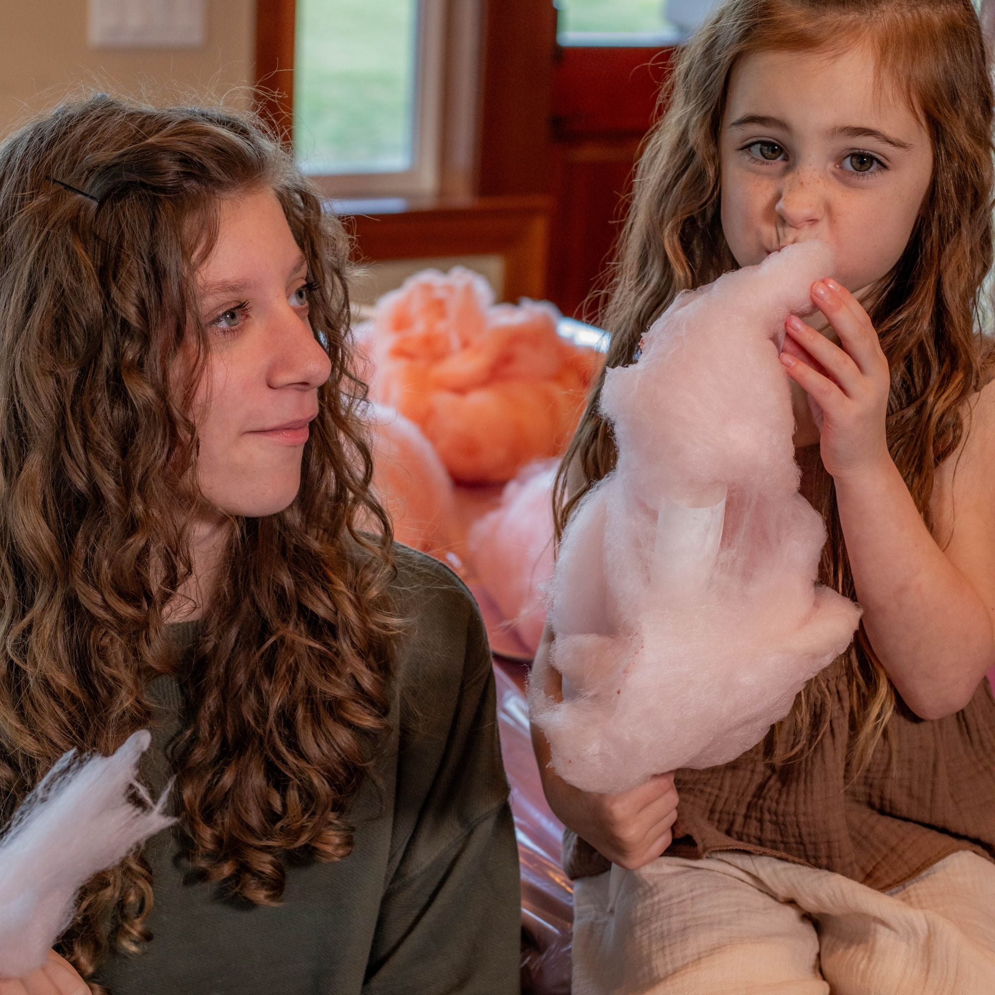 Kids enjoying strawberry cotton candy made with Colorwayz naturally colored cotton candy sugar