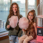 Kids holding fresh watermelon cotton candy made with Colorwayz dye-free cotton candy sugar using home cotton candy machine, family-friendly natural candy